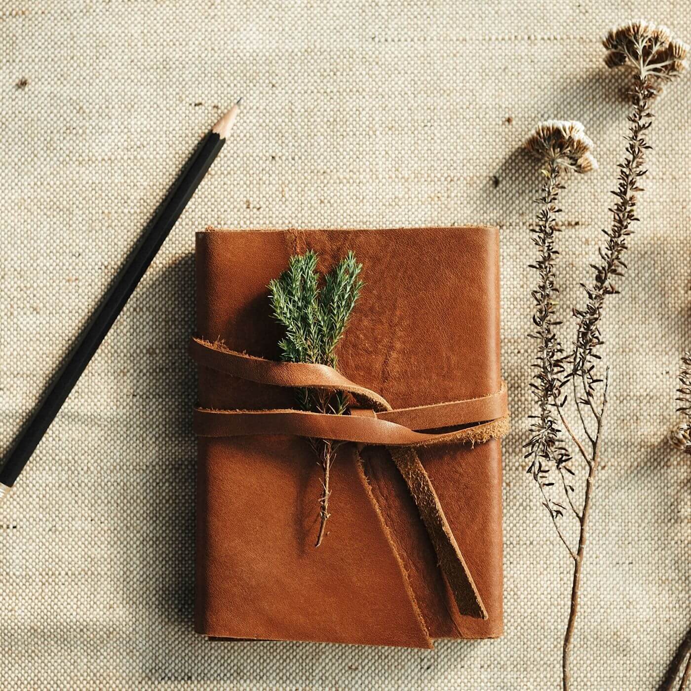 Leather note book on linen surface